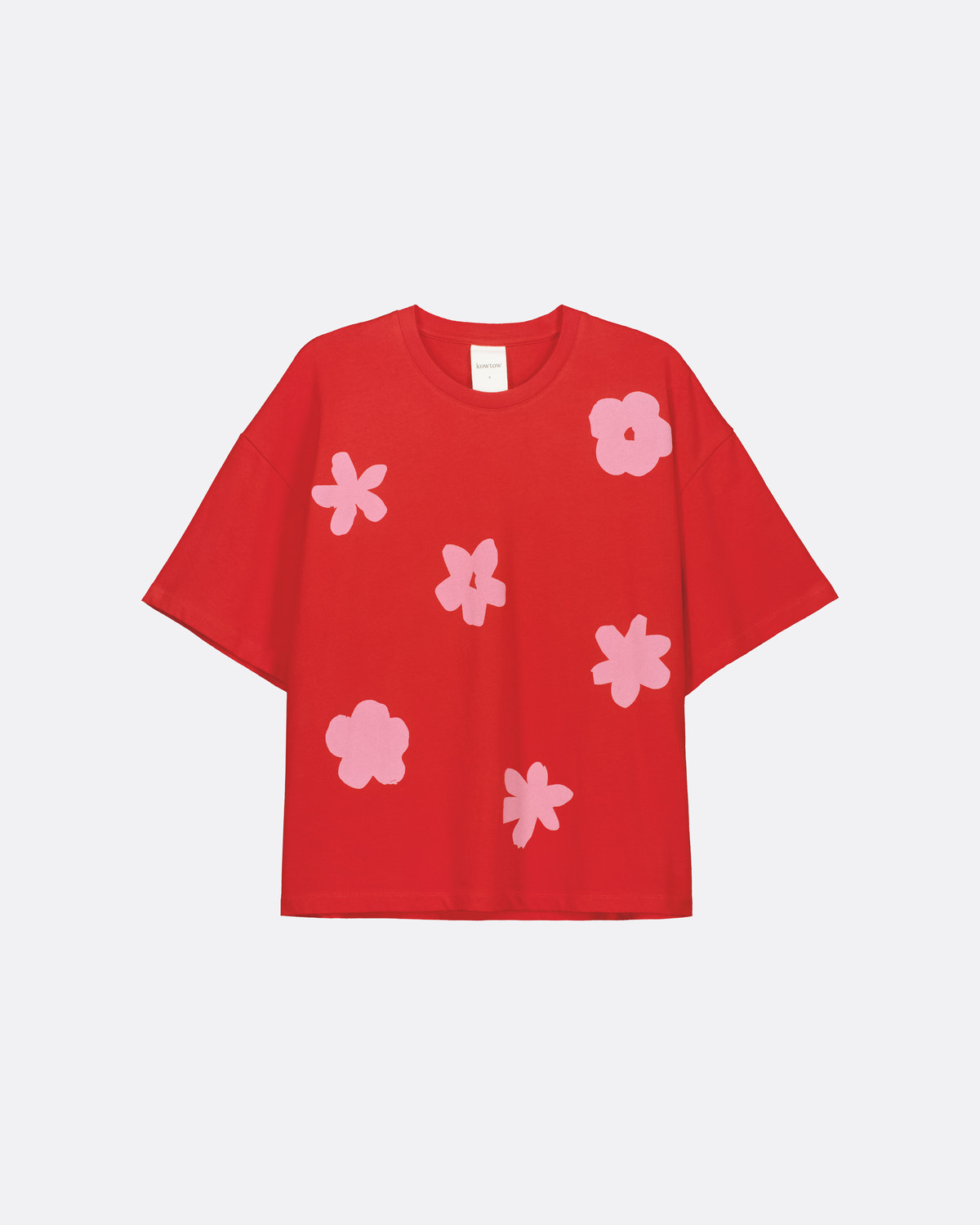 A red short-sleeve t-shirt with a pattern of light pink abstract flower shapes, displayed flat against a light gray background.