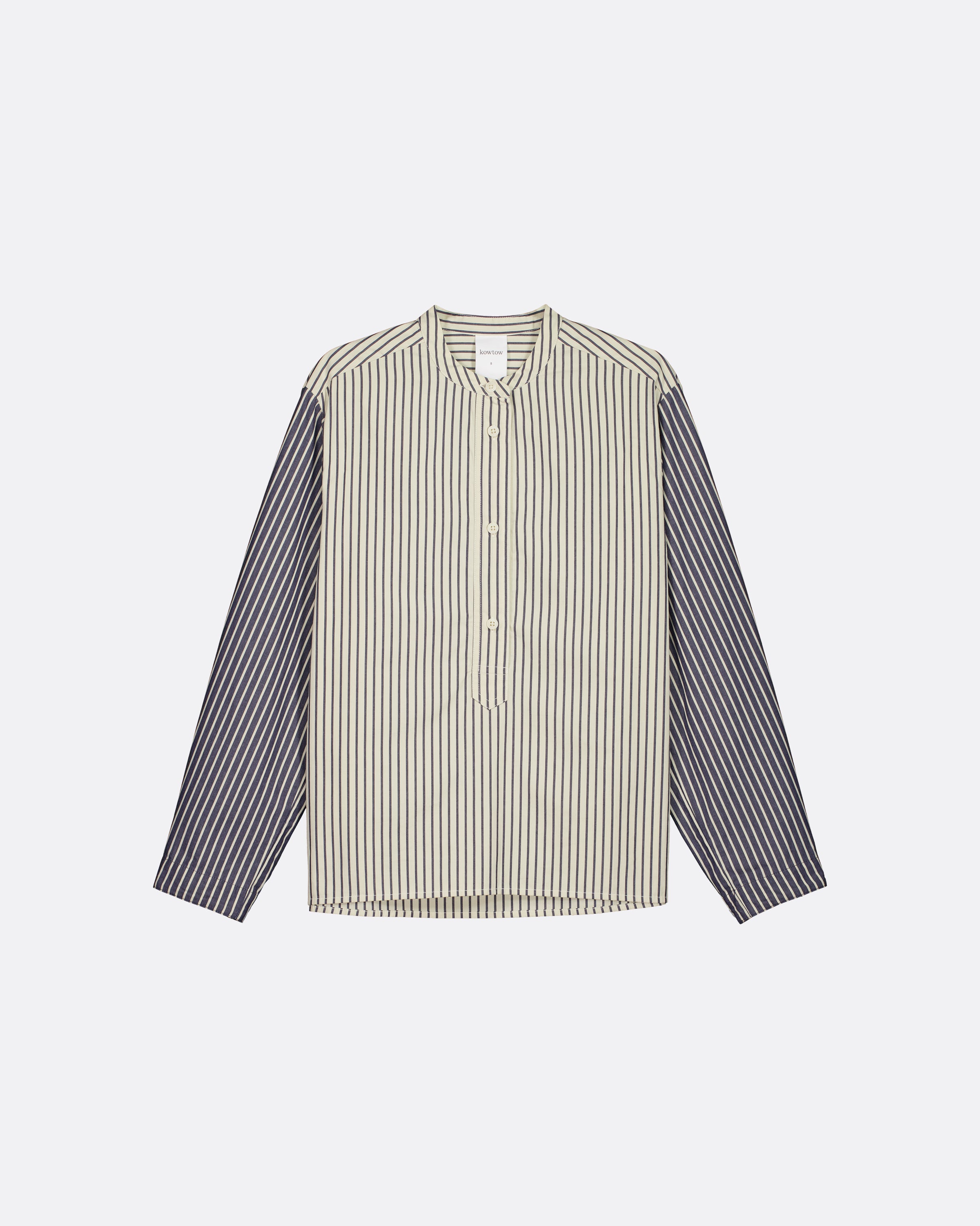 A long-sleeve button-up shirt with a beige and white vertically striped body and solid dark gray sleeves, displayed flat against a light gray background.