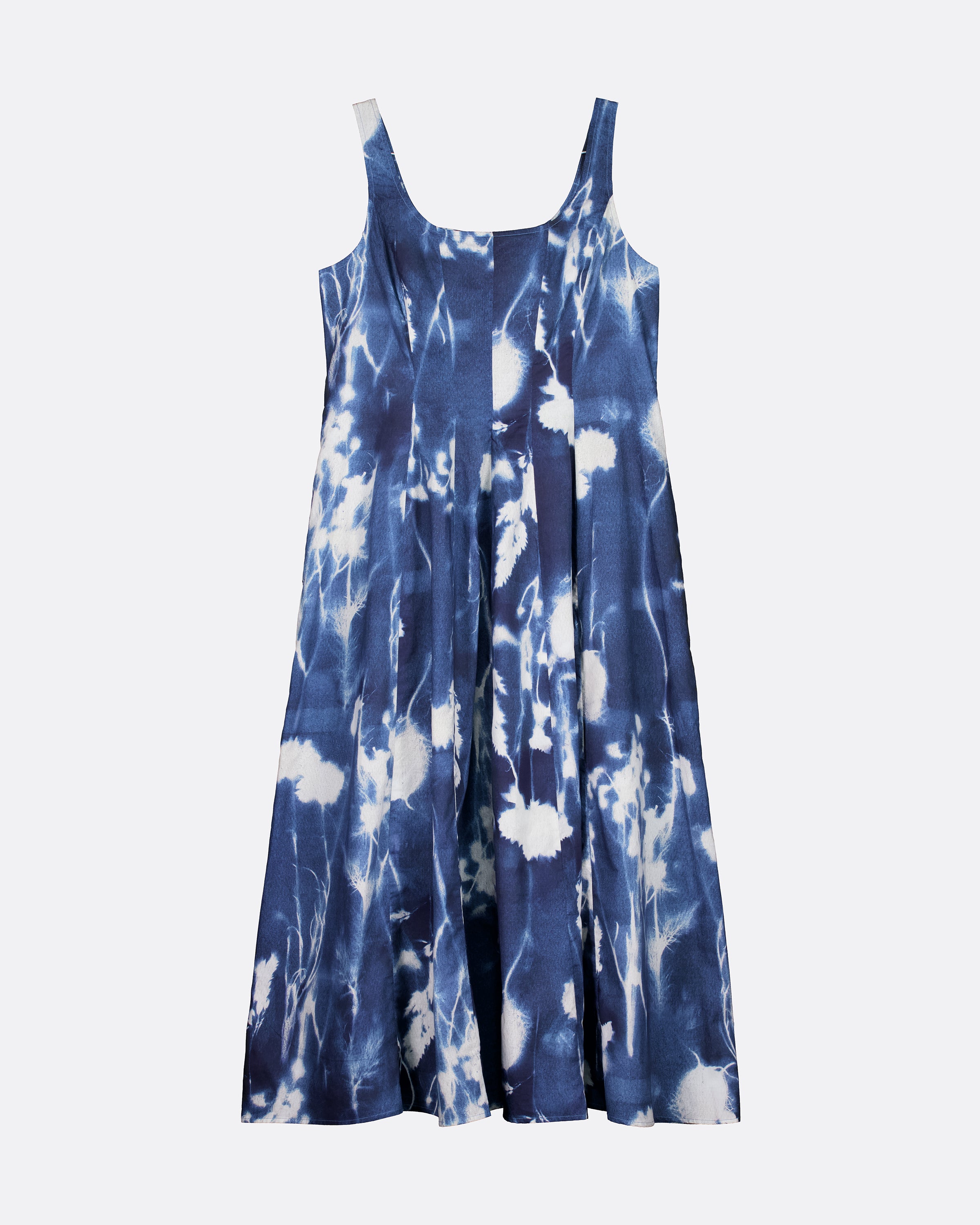 A sleeveless blue and white tie-dye dress with a scoop neckline and thin shoulder straps, shown against a plain light gray background.