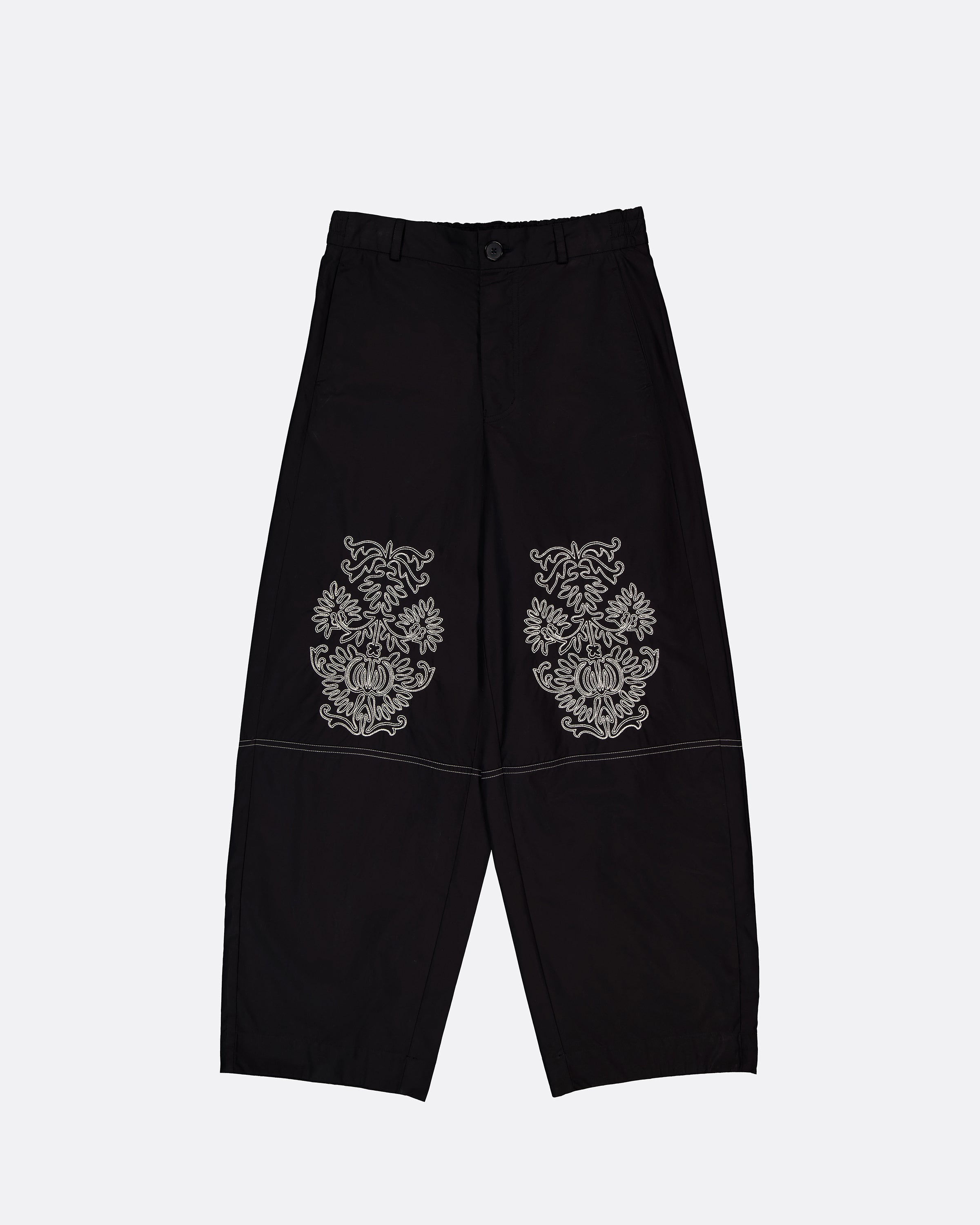 Black wide-leg cropped pants with ornate silver embroidered motifs on the upper thighs, displayed flat against a light gray background.