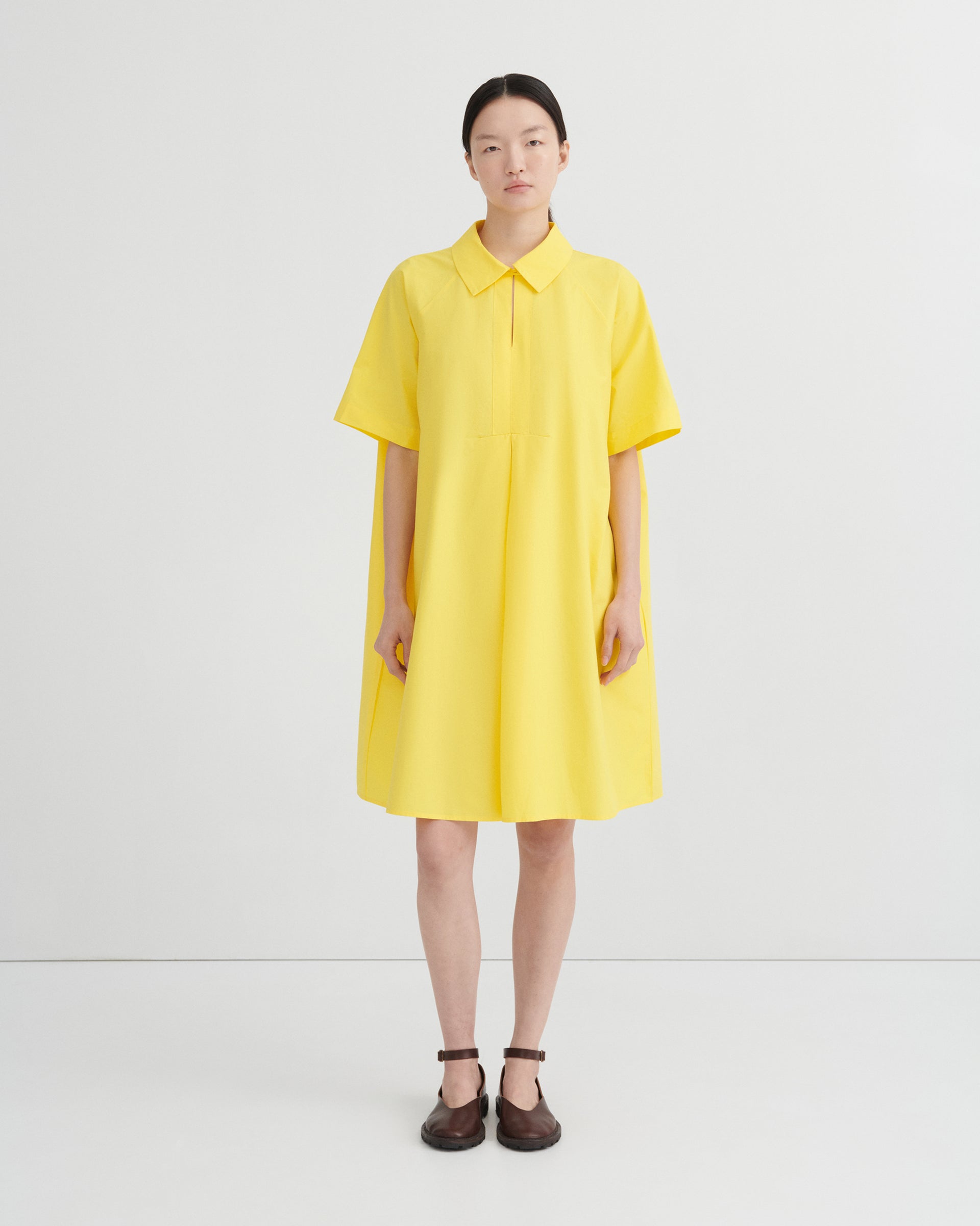 Women wearing a yellow dress and brown shoes.