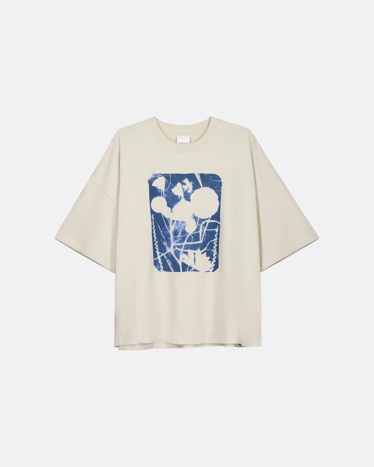 A cream-colored short-sleeve t-shirt with a blue and white abstract graphic print on the front, displayed against a light gray background.