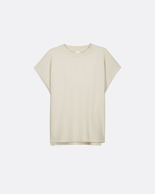 A light beige short-sleeve crewneck t-shirt with a relaxed, oversized fit, displayed against a clean, light gray background.