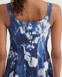 Blue and white tie-dye dress with buttons on a plain background