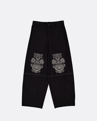 Black wide-leg cropped pants with ornate silver embroidered motifs on the upper thighs, displayed flat against a light gray background.